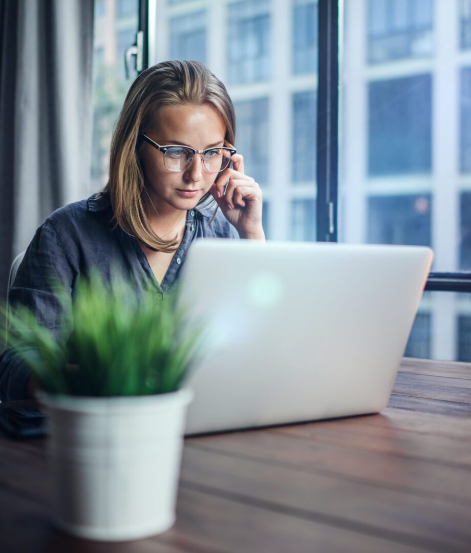 Woman working on laptop. Freelancer at remote work. Female student learning on-line via computer. Blogger or journalist writing new article.